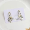 White earrings, four-leaf clover