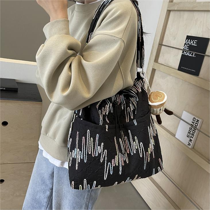 Alto sentido de la bolsa de lona de transporte casual versátil2024 nuevo bolso de mujer de verano popular gran capacidad bolso de cubo