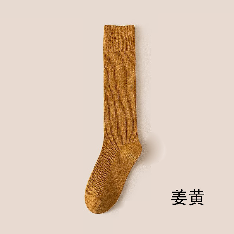 縦条のふくらはぎの靴下の女性の春秋の圧力の長い筒の靴下はやせていることができます。