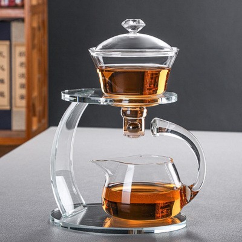 Fábrica al por mayor de vidrio resistente al calor taza de té perezoso traje hogar Kung Fu juego de té engrosada tetera de succión magnética Fabricación de té automática