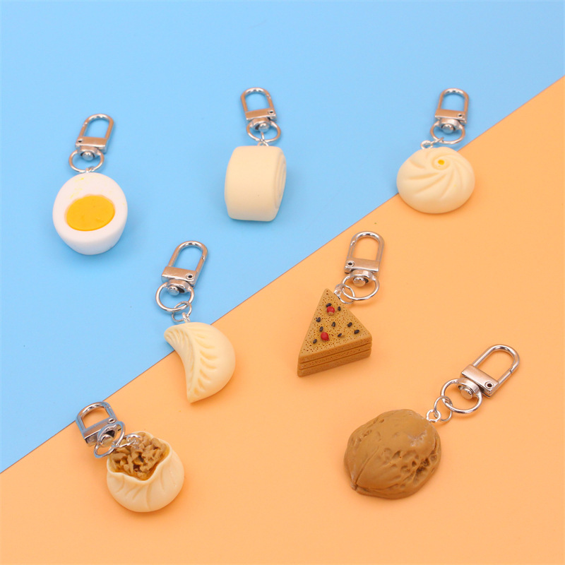 Creatieve, schattige en realistische sleutelhanger in de vorm van een voedselmodel, een leuk cadeau voor kleuters. Het speelgoed heeft de vorm van dumplings en is een gestoomd kerstcadeau._voghion.com