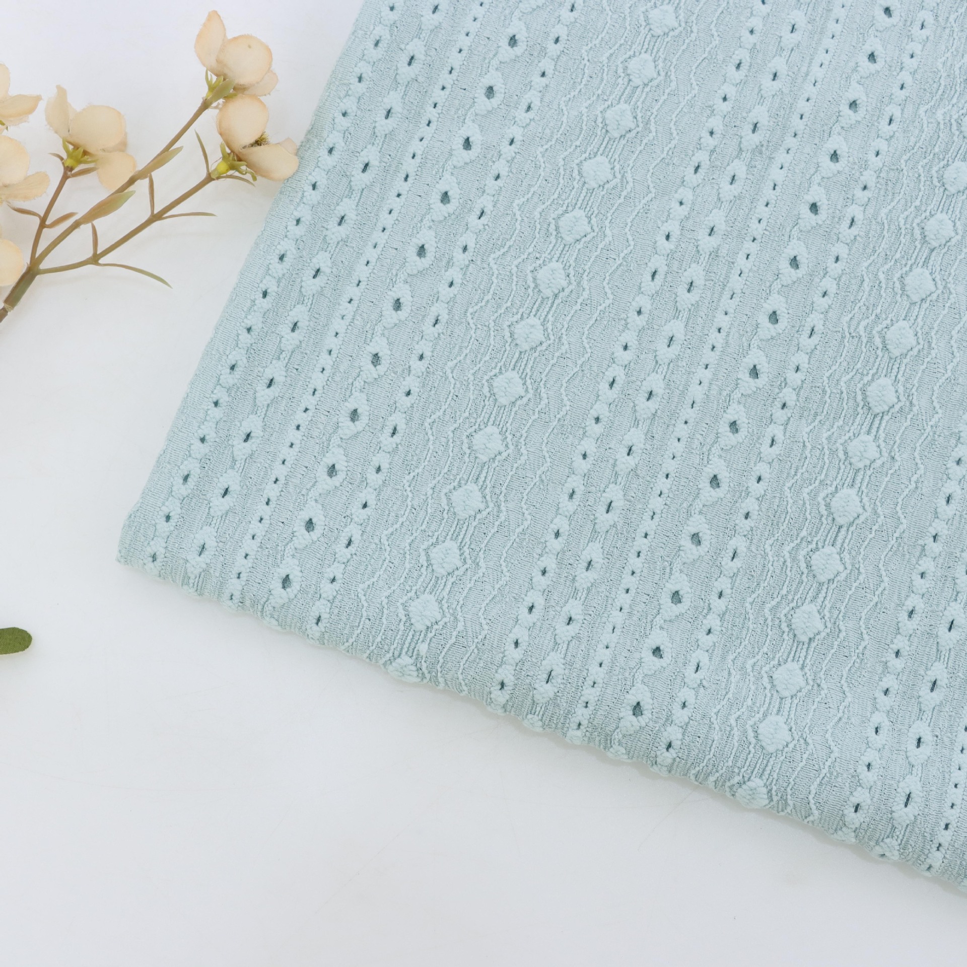 170g经编涤氨提花针织面料几何洞洞经编提花时尚百搭女装面料