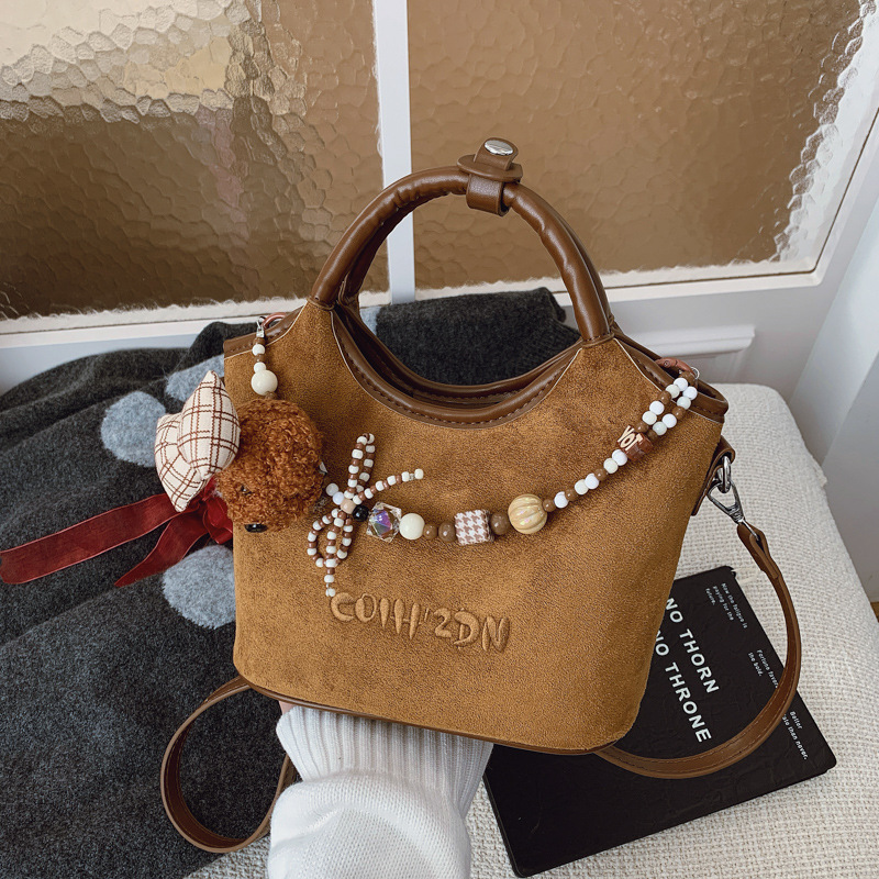 Otoño 2025 nuevo perro cuentas bolso de cubo bolso de viaje femenino estilo coreano retro mochila de hombro esmerilado