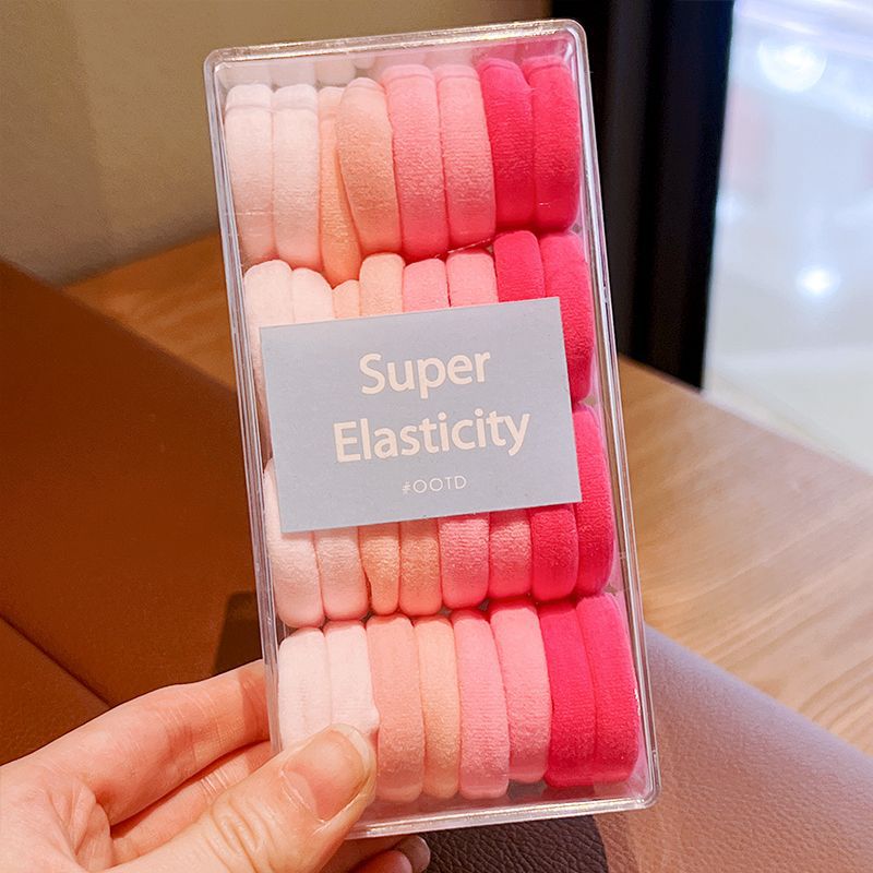 32 cajas de anillos para el cabello rosa