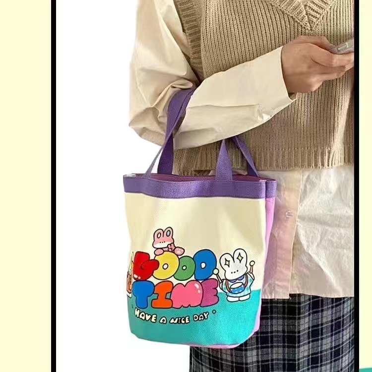 かわいい落書きバケツバッグinsプリント円筒バッグキャンバス弁当袋韓風少女は弁当箱を持っています。|undefined