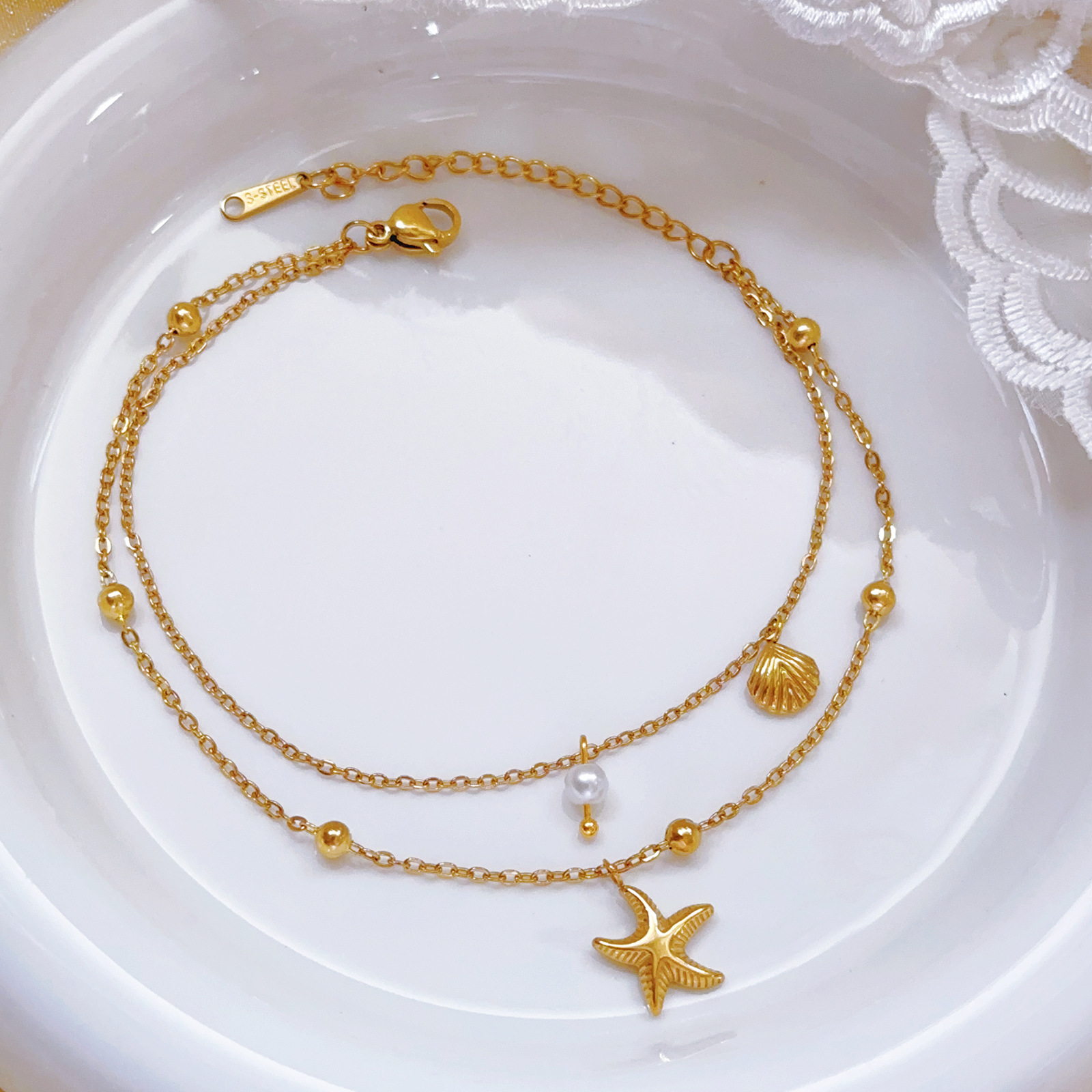 Nuevo estilo transfronterizo europeo y americano, cadena de pie de concha de estrella de mar, lujo ligero, nicho, tobillera de viento frío, joyería de todo fósforo de lujo ligero femenino