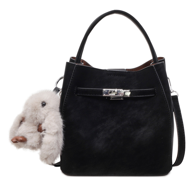 Bolso de mano de viaje retro coreano para mujeres 2025 nuevo paquete de cubo de hombro casual de alto nivel sensación de mochila versátil