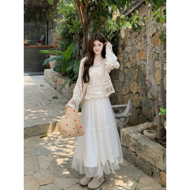 Реальный снимок нового весеннего комплекта 2025 года: женская блузка с V-образным вырезом и ажурными вырезами, вязаная, и юбка-сетка средней длины.