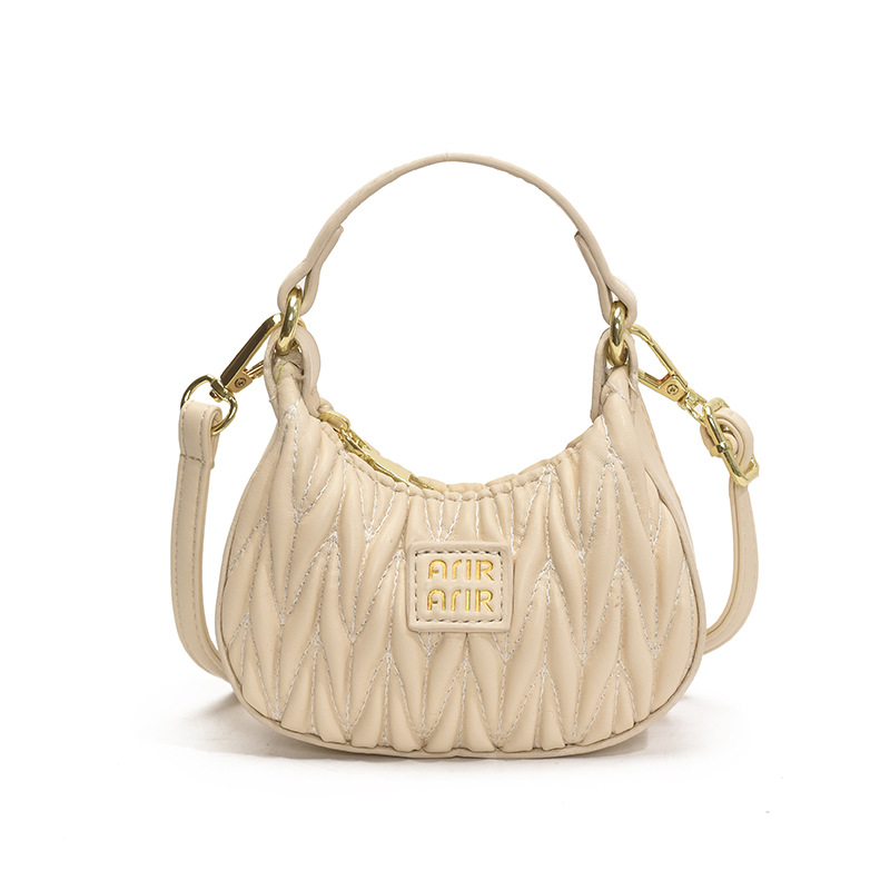 Versión coreana del bolso de hombro de niña de color sólido simple estilo occidental mini bolso de la axila portátil del bebé nuevo bolso de los niños plisado