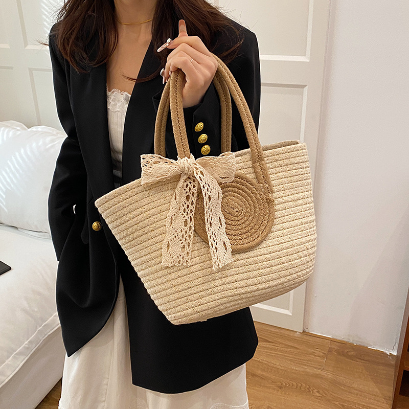 Bolsa de moda de color contrastante portátil de tejido de mujer 2025 tendencia primavera nuevo retro versátil arco bolso de cubo de mano