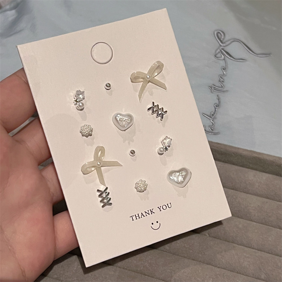 Elegant fashionable universal earrings with bow from pearl