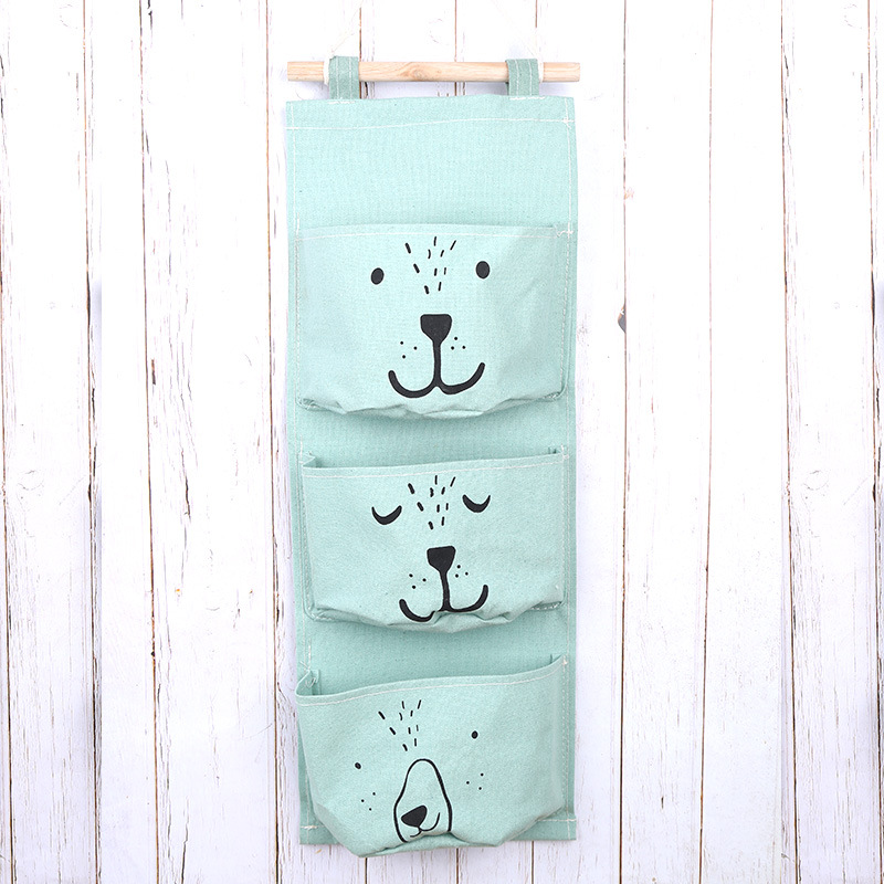 Suministro de algodón y lino de dibujos animados expresión de tres bolsillos de una pieza de almacenamiento bolsa colgante semicírculo bolsa colgante decorativa bolsa colgante