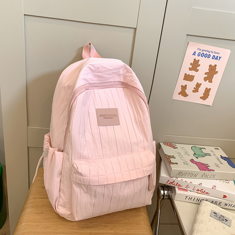 패션 여행 경량 중학생 및 대학생 클래스 솔리드 컬러 배낭 2024 새로운 간단한 틈새 디자인 학교 가방