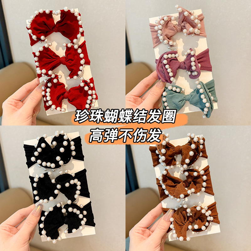 Arco de perla máscara anillo de cabello femenina baja cuerda de cabello bola adornamiento de cabello correa de cuero cuerda de cabello al por mayor