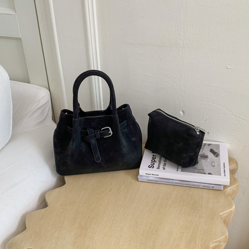 Diseño de nicho simple bolso de cubo portátil para mujeres 2026 nuevo estilo coreano de textura de alta calidad casual versátil bolso de tramo inclinado