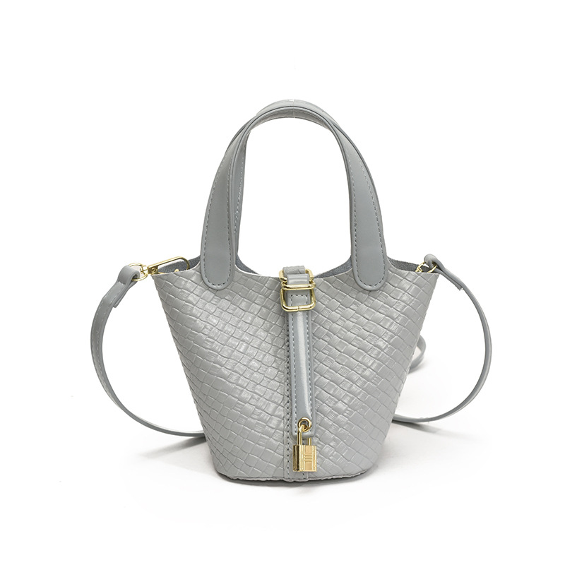 Bolso de cubo portátil con patrón tejido para mujer 2025 nuevo estilo coreano de lujo ligero de alta gama bolso de mensajero para niños de nicho