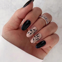 Mid-length oval-shaped round-toe nail art: Black silhouette leaf-style false nails—sleek, edgy, and perfect for a sweet-cool European-American Instagram-inspired look.