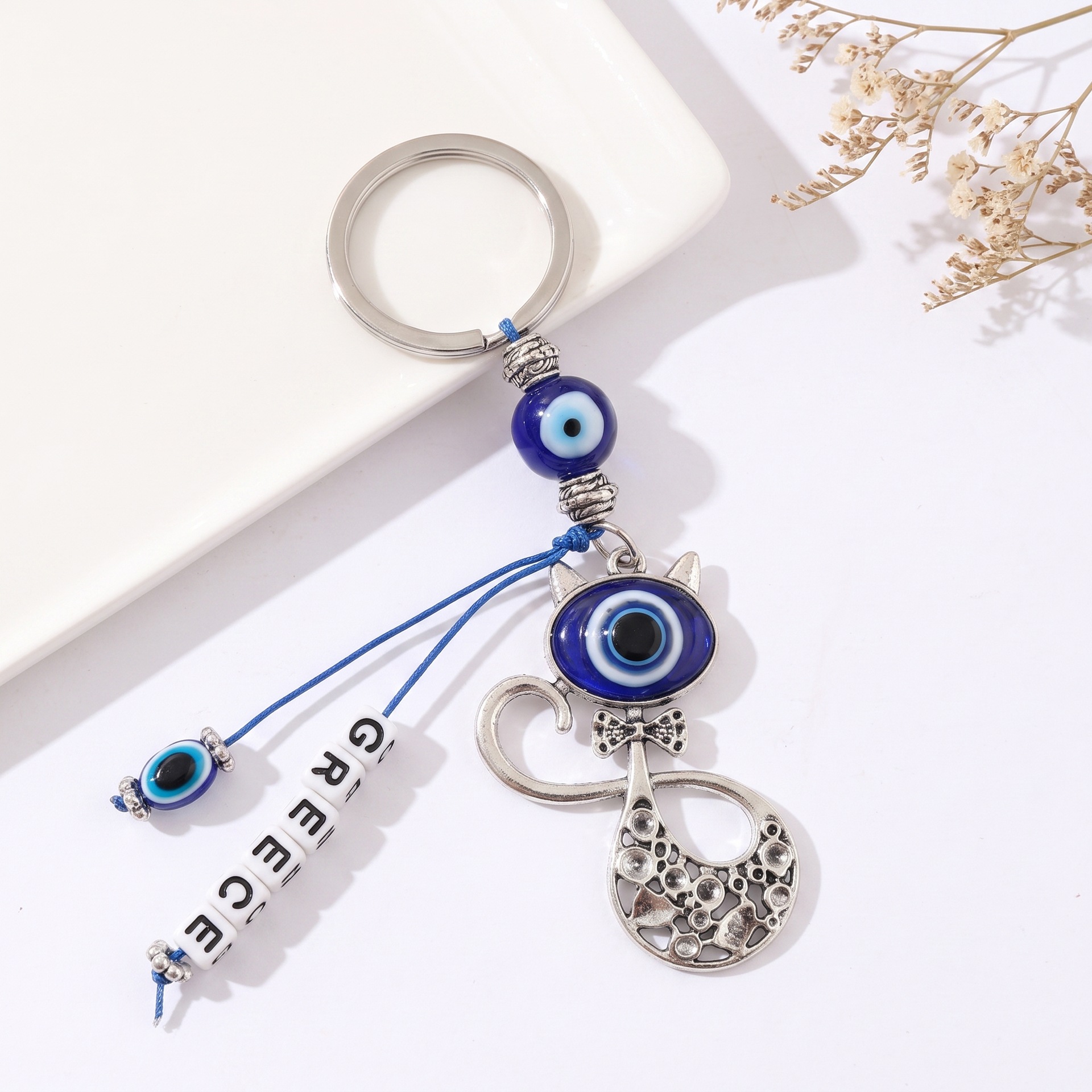 Transfronterizo retro turco ojos azules gatos llaveros letras griegas colgantes bolsas de ojos del diablo colgantes