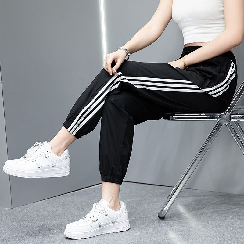 2023 Pantalones deportivos de primavera y otoño pantalones largos casuales para hombres y mujeres Comercio exterior Pareja juvenil suelta slim fit pantalones de chándal atados al tobillo