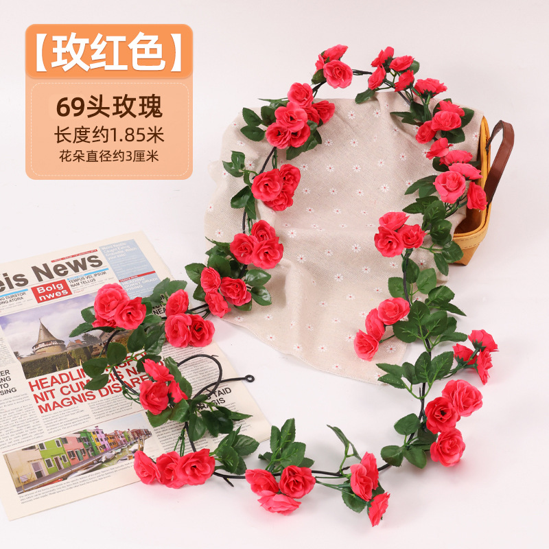 Simulación de flores falsas rosas de caña colgando la pared tubería de drenaje envuelta hoja verde que cubre la parte superior de la decoración de boda de plástico