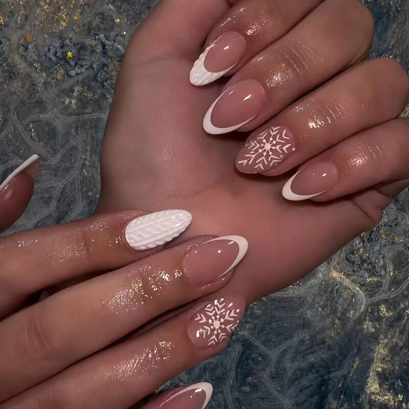Christmas-themed medium almond-shaped nail tips in white series with snowflake pattern embellishments, ready-to-wear nail products wholesale