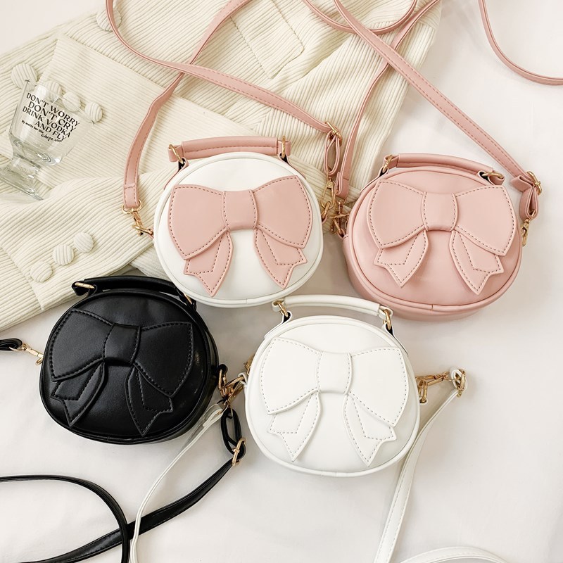 Bolsos para niños mini lindos arcos para hombres y mujeres, bolsos redondos para niños 2025 moda coreana nueva bolsa de cambio para niños