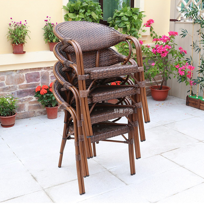 Outdoor set of wicker chairs, tables, and benches for courtyard, garden, balcony, and reception area, simple dining room furniture for outdoor terrace