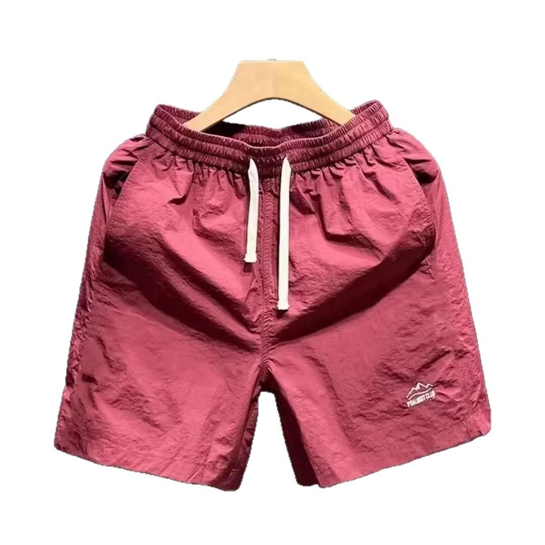 Verano al aire libre montañas y ríos pantalones cortos de color sólido para hombres pantalones de cinco puntos de playa sueltos de secado rápido comercio exterior al por mayor transfronterizo