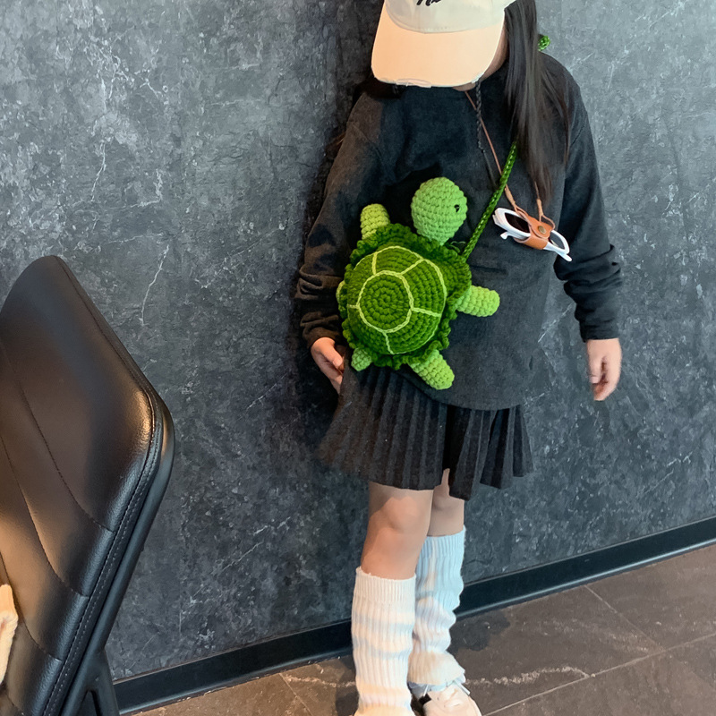 2025 otoño y invierno nuevo bolso infantil lana gancho tejido pequeña tortuga bebé bolso de cambio caricatura lindo mochila de hombro