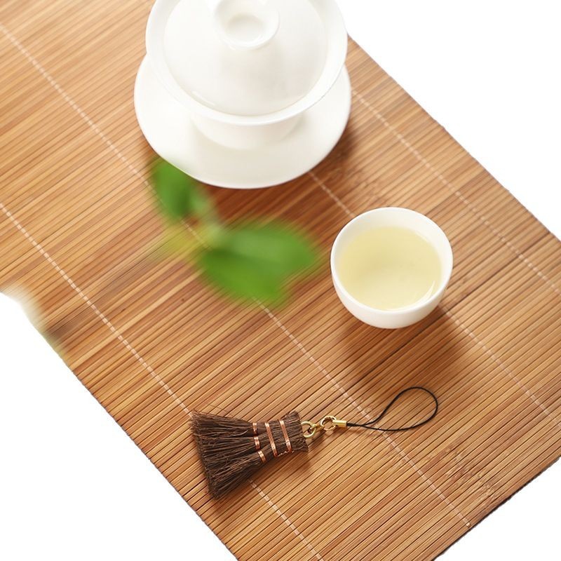 茶色の毛の茶器の文章はブラシでお茶の茶器の茶器の茶器を掃除して水を掃除します。|undefined