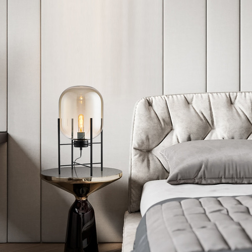 Postmodern Nordic industrial style smoke gray glass four-legged floor lamp with creative and personalized design for living room and bedroom.