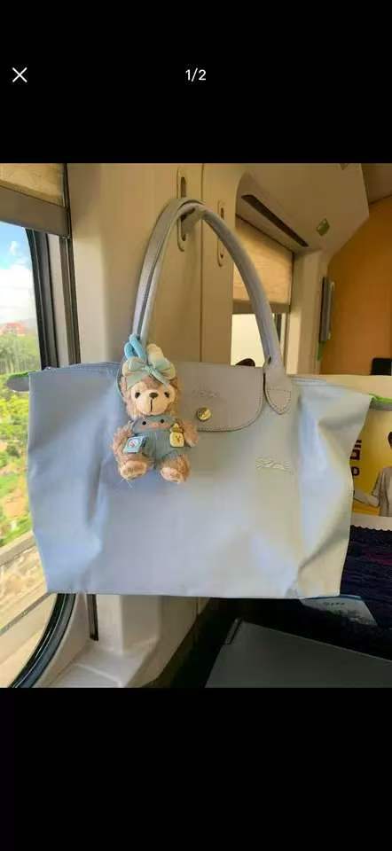 フランスの竜は高く上げてナイロンのカバンを包んで、女性のカバンの長い柄はギョーザの包みを持って折り畳みます。