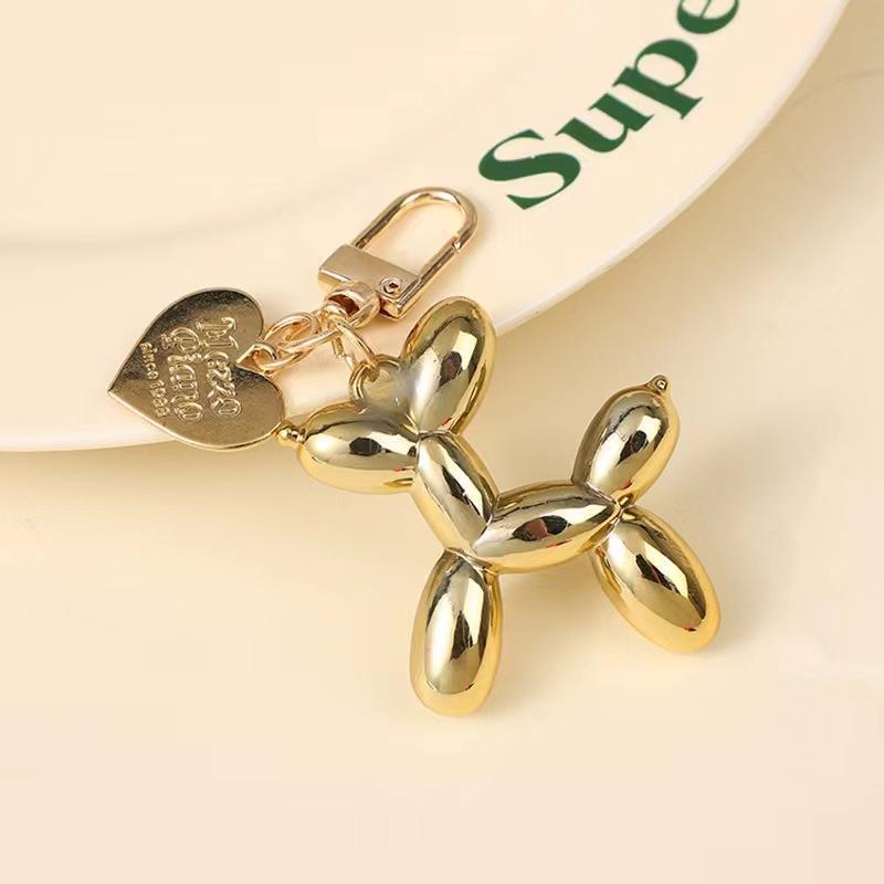 Perro dorado + botón de amor dorado