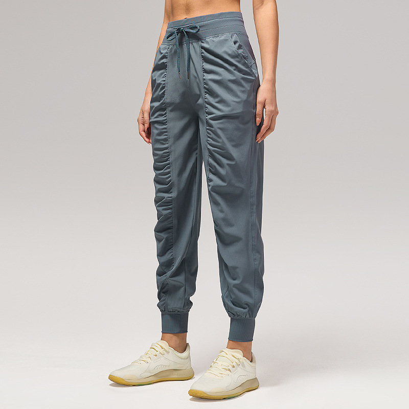 Pantalones deportivos casuales sueltos de mujer plegados para correr pantalones de yoga de nueve puntos de bolsillo secado rápido pantalones de pies transpirables