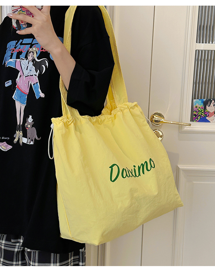 Solid color large-capacity tote bag 2025 bestseller, fashionable commuting lightweight handbag, laid-back style drawstring nylon bag for women undefined