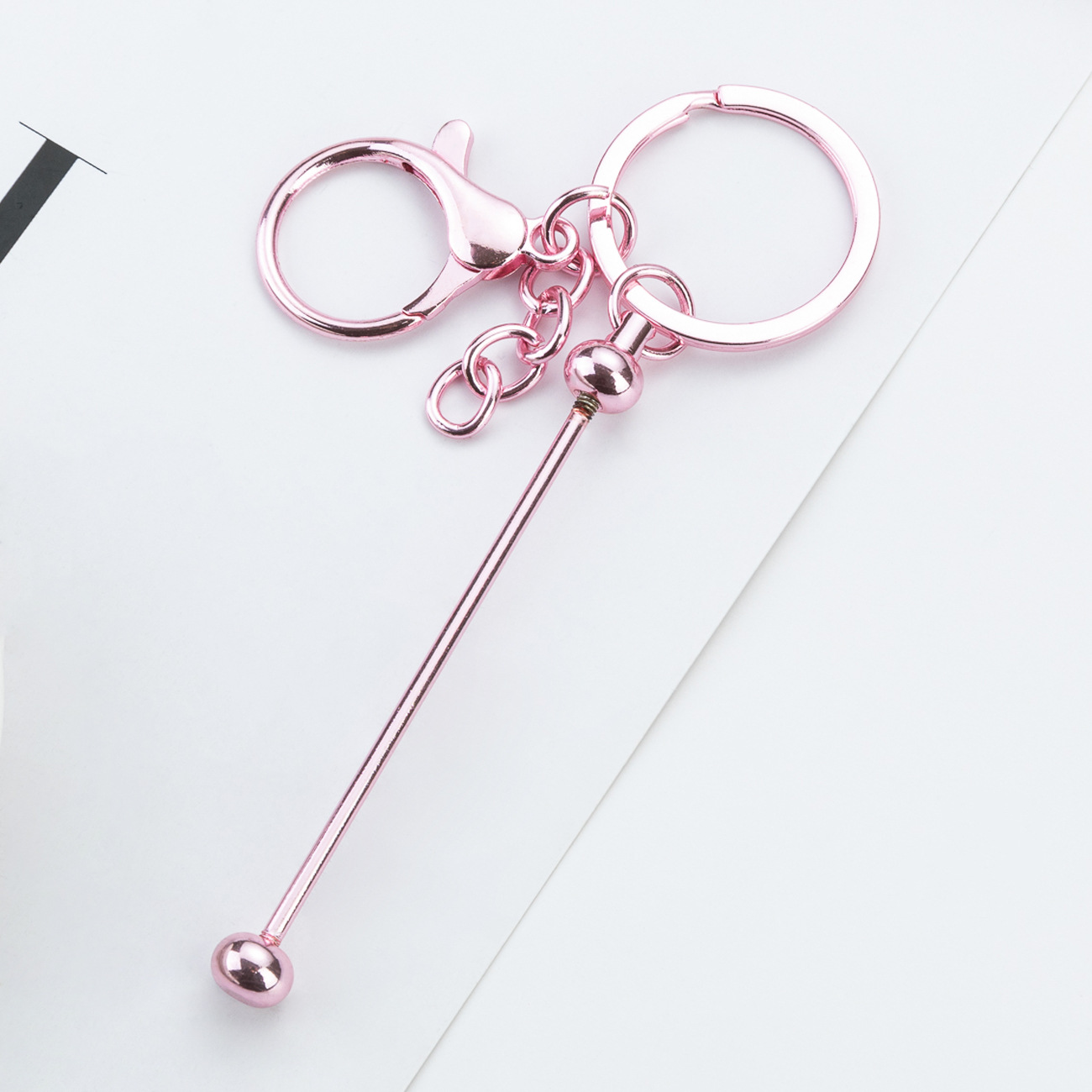 DIY cuentas llaveros auriculares caja de teléfono celular colgante llaveros de metal chapeado UV llaveros al por mayor spot