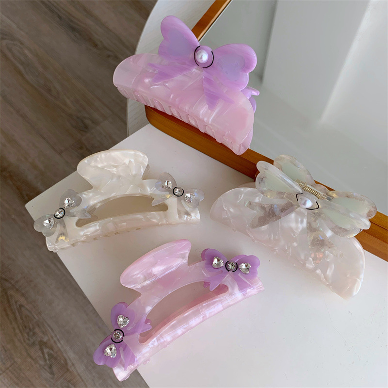 Women's Sweet Simple Style Bow Knot Acetic Acid Sheets Hollow Out Inlay Rhinestones Pearl Hair Claws display picture 1