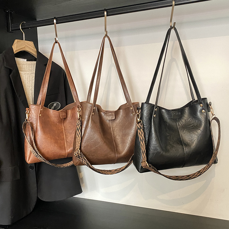 Europa y los Estados Unidos retro gran capacidad de transporte tote2025 nuevo bolso textura ancha cintura de hombro mochila bolso de hombro