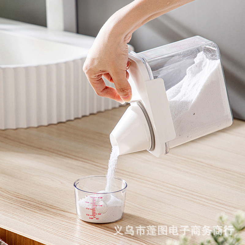 Transparent, portable laundry detergent storage jar with measuring cup—ideal for dispensing and storing laundry care products in a moisture-proof, airtight container.