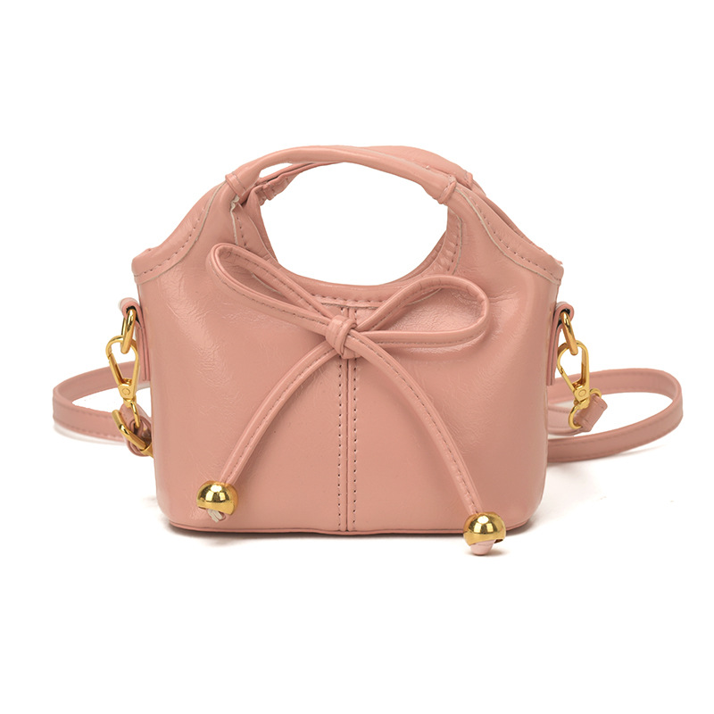 Bolsas infantiles transfronterizas de moda coreana de color sólido, bolsas de mano de chicas, mini bolsas de cestas de arco lindas