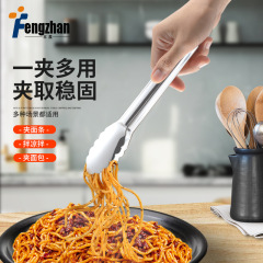 厚いステンレスの梅のパンの食べ物を挟んで台所のステーキの専用のクリップを焼きます。