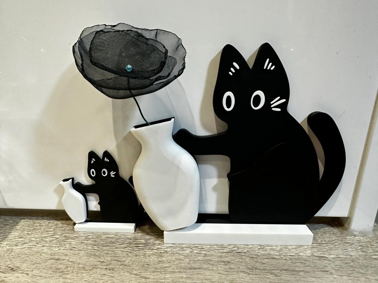 A mischievous kitten (on an overturned vase)