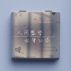 A vintage-style makeup mirror with small text, portable and foldable, for touch-ups, dual-sided mirror.