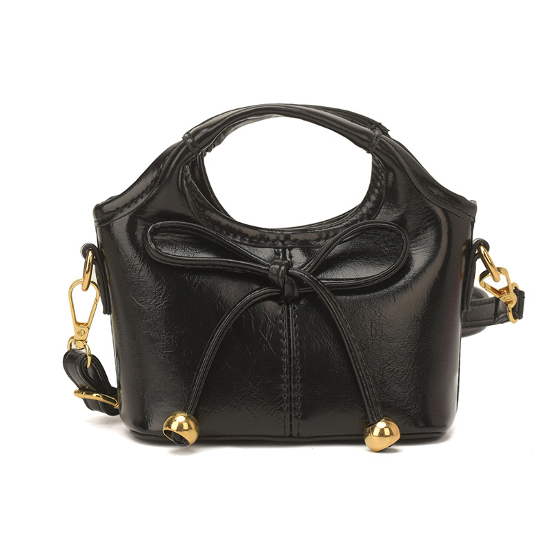 Bolsas infantiles transfronterizas de moda coreana de color sólido, bolsas de mano de chicas, mini bolsas de cestas de arco lindas