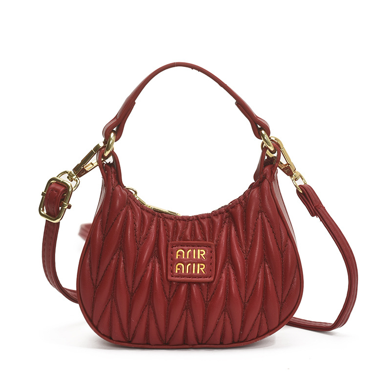 Versión coreana del bolso de hombro de niña de color sólido simple estilo occidental mini bolso de la axila portátil del bebé nuevo bolso de los niños plisado