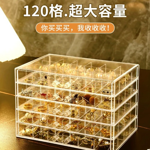 A transparent jewelry box with compartments for earrings, necklaces, rings, and beads