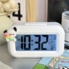 White alarm clock, ice-cream Pacha dog, battery