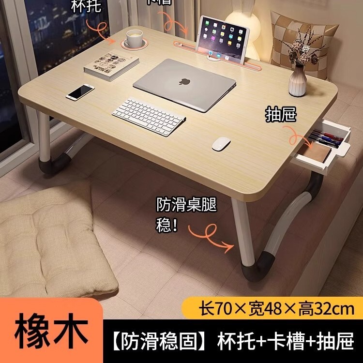 折り畳み可能なベッドの上の小さなテーブルは机のノートパソコンのテーブルを勉強します。|undefined