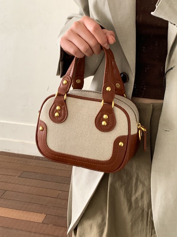 Hot sale nuevo lienzo empalme color contraste bolos portátiles de textura alta pequeña parte coreana nicho mochila de hombro