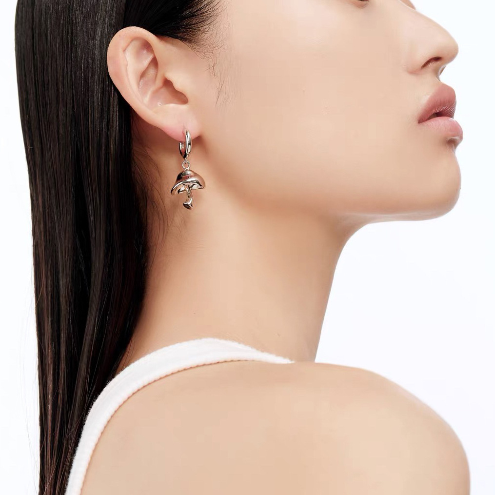 Asymmetrical small design earrings with zircon